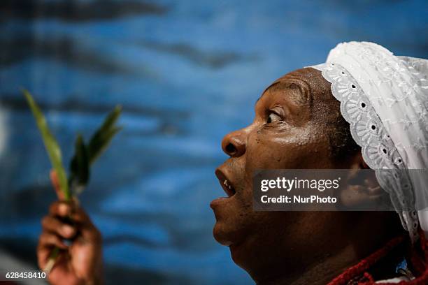 The babalorix with leaves that must be placed in the mouth of the ram that will be sacrificed. Members of the Jurema religion make animal sacrifices...