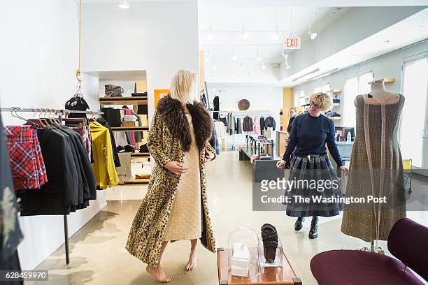 Nancy Pearlstein, owner of Relish, pulls garments for a customer, Jennifer Peacock and awaits feedback about the garment.