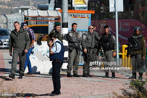 Israeli security forces gather at the site where a Palestinian was shot dead after reportedly attempting to stab Israeli border policemen, on...