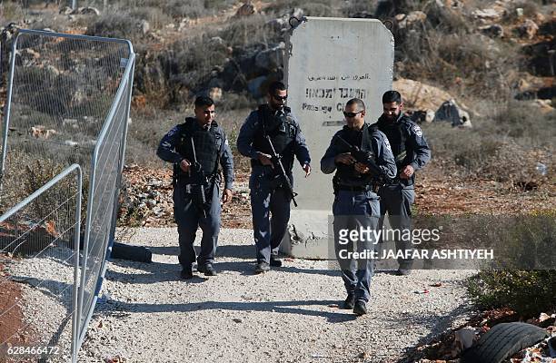 Israeli security forces gather at the site where a Palestinian was shot dead after reportedly attempting to stab Israeli border policemen, on...