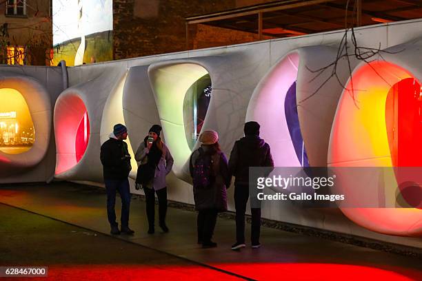 Visitors admire the uminous neon display in the open-air Art Walk passage during the Kocham Warszawe Swiatecznie Christmas Market on December 06,...