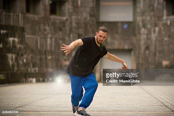 young male dancer practice dance on the street - hip hop culture stock pictures, royalty-free photos & images