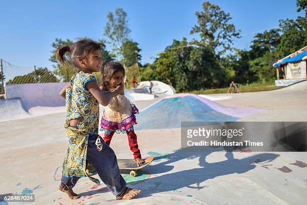 Young girls pose with their skate boards at Skating park, popularly known as Janwaar Castle on October 26, 2016 in Janwaar, India. Thanks to a German...