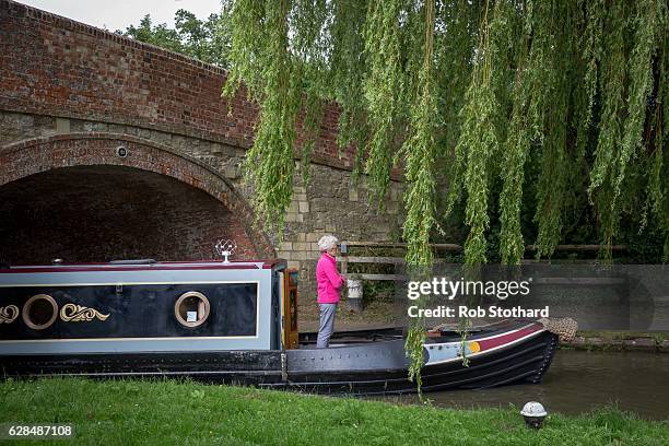 Woman navigates a canal boat down the Grand Union Canal on July 10, 2016 in Stoke Bruerne, England. South Northamptonshire is a constituency in...