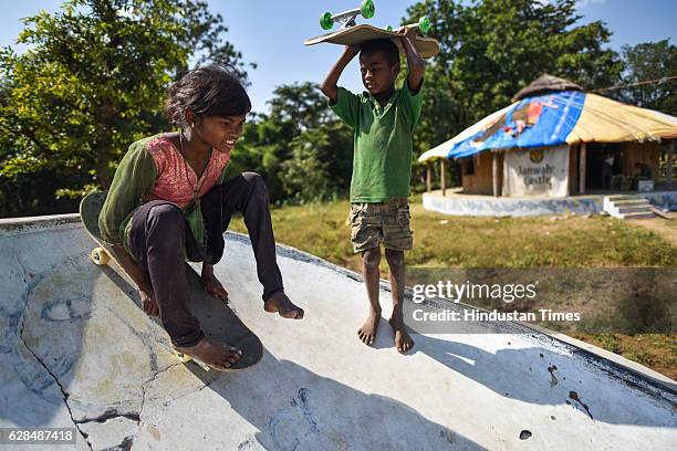 Young girl roll on her skate board as a boy waits for his turn at Skating park, popularly known as Janwaar Castle on October 26, 2016 in Janwaar,...