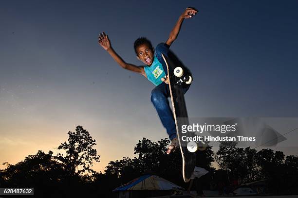 Against the fading light of the evening sky, Ramkesh, age 10, squeezes in one final jump for the cameras at Skating park, popularly known as Janwaar...