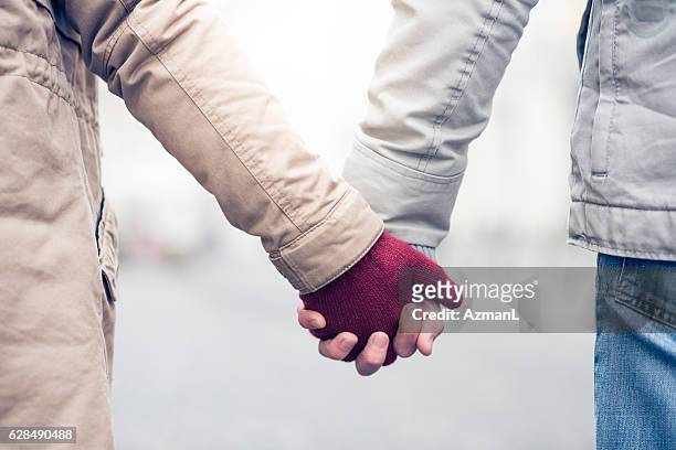 love is in the air - young couple holding hands stock pictures, royalty-free photos & images