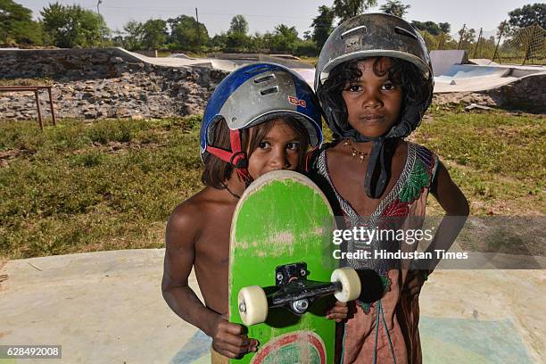 Young girls pose with their skateboards at Skating Park, popularly known as Janwaar Castle, on October 26, 2016 in Janwaar, India. Thanks to a German...