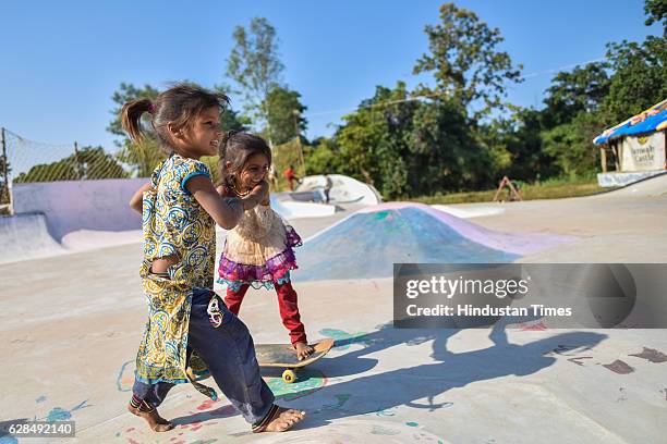 Young girls pose with their skateboards at Skating Park, popularly known as Janwaar Castle, on October 26, 2016 in Janwaar, India. Thanks to a German...