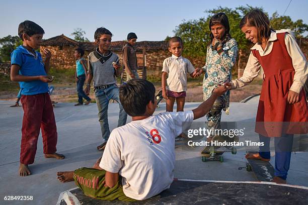 Children sharing a fruit at Skating Park, popularly known as Janwaar Castle, on October 26, 2016 in Janwaar, India. Thanks to a German community...