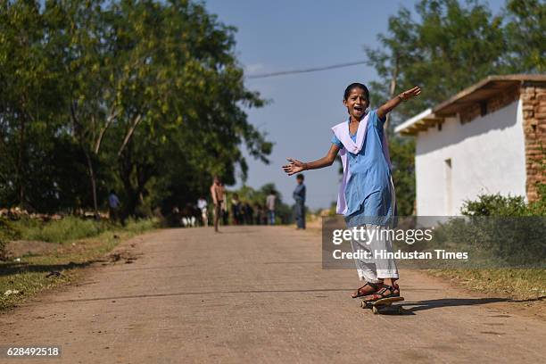 Girl rolls down the road in her school uniform on October 26, 2016 in Janwaar, India. Thanks to a German community activist and author Ulrike...