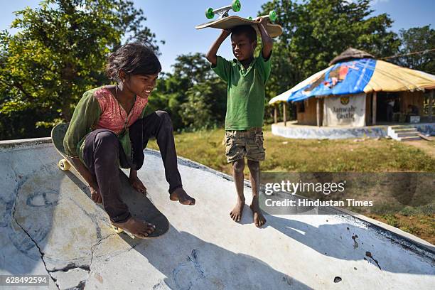 Young girl rolls on her skateboard as a boy waits for his turn at Skating Park, popularly known as Janwaar Castle, on October 26, 2016 in Janwaar,...