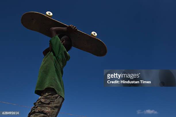 Young boy with his skateboard at Skating Park, popularly known as Janwaar Castle, on October 26, 2016 in Janwaar, India. Thanks to a German community...
