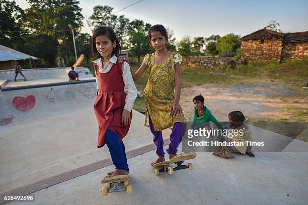 Young girls pose with their skateboards at Skating Park, popularly known as Janwaar Castle, on October 26, 2016 in Janwaar, India. Thanks to a German...