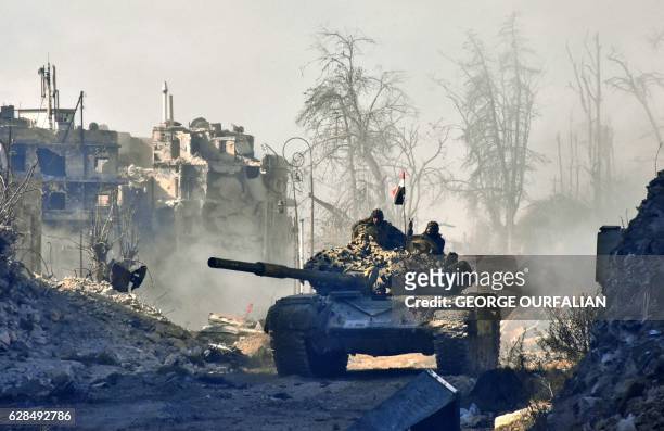 Syrian pro-government forces manoeuver a tank in the newly retaken area of Sahat al-Melh and Qasr al-Adly in Aleppo's Old City on December 8, 2016....