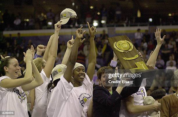 Head coach Muffet McGraw holds the NCAA championship trophy after Notre Dame beat Purdue 68-66 to win the NCAA Women's Basketball Championship Game...