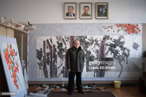 In this photo taken on November 28 artist Ri Gyong-Ran poses for a photo at the Mansudae Art Studio where he works in Pyongyang. / This photo package...