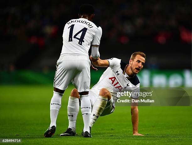 Georges-Kevin N'Koudou of Tottenham Hotspur helps Harry Kane of Tottenham to his feet during the UEFA Champions League match between Tottenham...