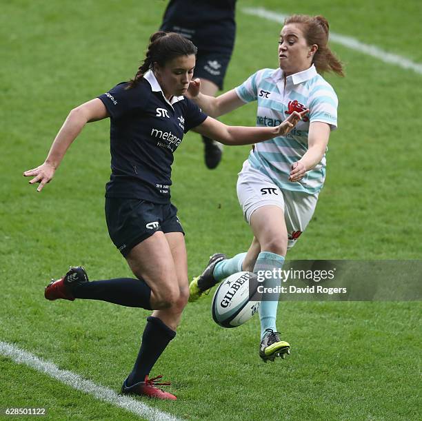 Sophie Trott of Oxford clears the ball past Imogen Duffy during the Women's Varsity match between Cambridge University and Oxford University at...