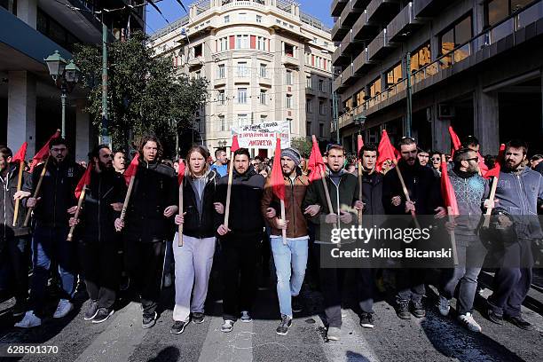 Protesters march and shout slogans as thousands of people take part in a demonstration on December 8, 2016 in Athens, Greece. A nationwide 24-hour...