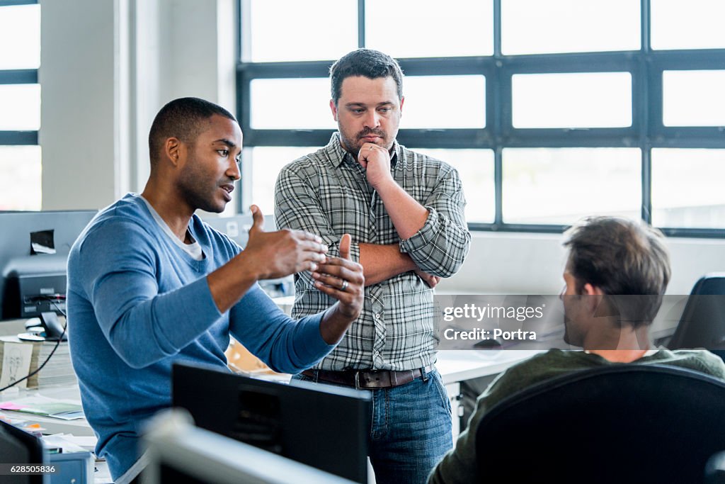 Businessmen discussing in creative office