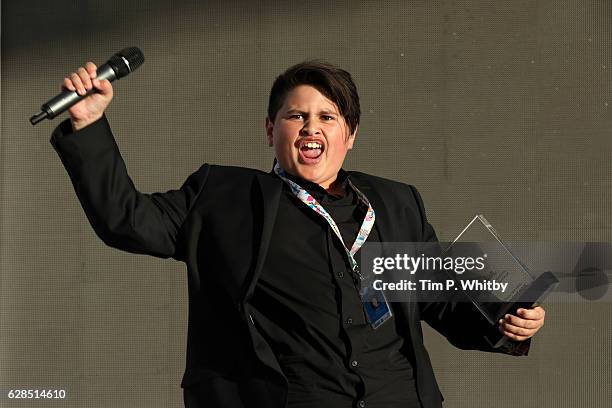 Julian Dennison cheers with his award at the award ceremony during the Ajyal Youth Film Festival on December 5, 2016 in Doha, Qatar.
