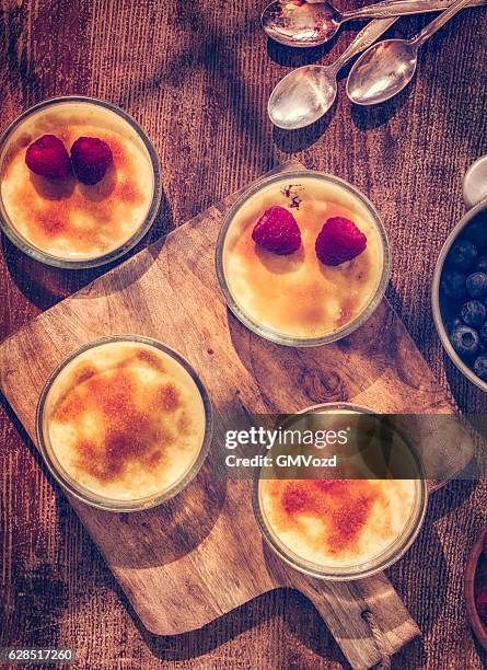 homemade creme brulee with berries - flan stock pictures, royalty-free photos & images