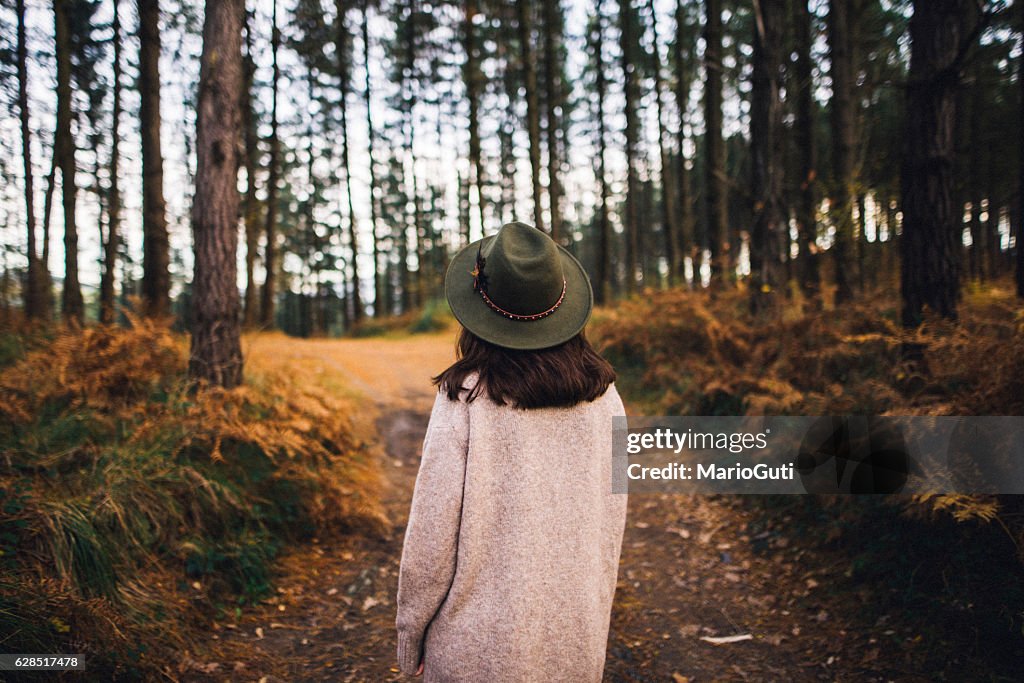 Young woman with hat at forest