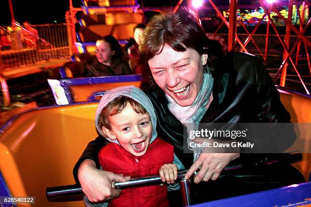 a woman and boy enjoying a rollercoaster ride at an amusement park. - fahrgeschäft stock-fotos und bilder