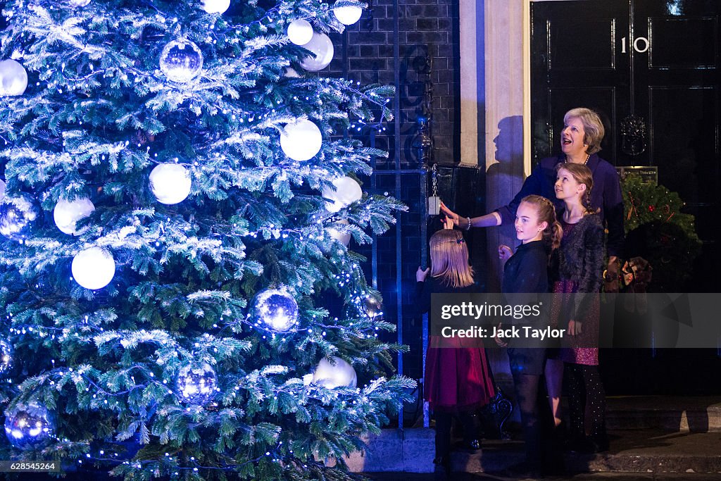 Theresa May Turns On The Downing Street Christmas Lights