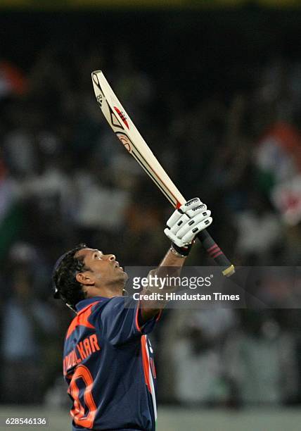 India batsman Sachin Tendulkar raises his bat after his century during the 5th ODI between India and Australia at Rajiv Gandhi stadium, Hyderabad.