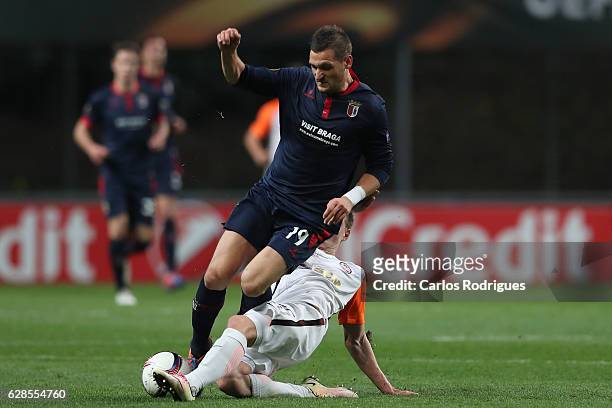 Braga's midfielder Nikola Stojiljkovic from Serbia tackled by FC Shakhtar Donetsk's defender Mykola Matviyenko during the UEFA Europe League match...