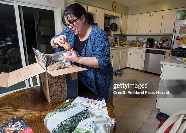 Emily Griffin unpacks the Blue Apron meal box at her home in Lisbon Falls. Every week Griffin receives three complete meals along with recipes and...