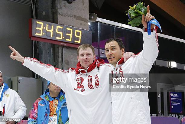 Russia - Alexander Zubkov and Alexey Voevoda of Russia celebrate after winning the gold medal in the men's two-man bobsleigh at the Winter Olympics...