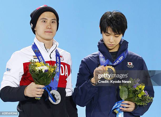 Russia - Men's figure skating champion Yuzuru Hanyu of Japan and silver medalist Patrick Chan of Canada are pictured with their medals on Feb. 15 at...