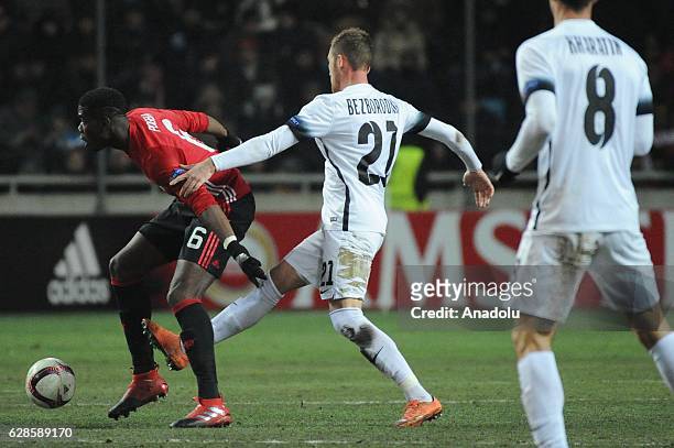 Denys Bezborodko of FC Zorya Luhansk competes for the ball with Paul Pogba of Manchester United during the UEFA Europa League group A match between...