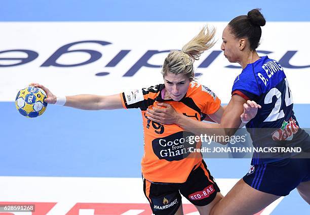 Netherlands' Estavana Polman and France's Beatrice Edwige vie for the ball during the Women's European Handball Championship Group B match between...
