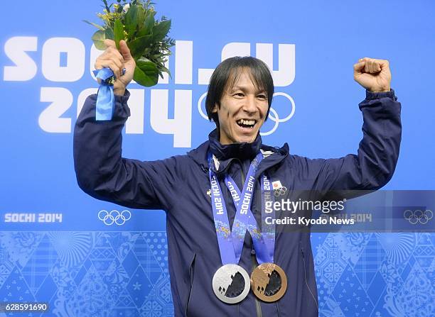 Russia - Noriaki Kasai of Japan celebrates with his silver and bronze medals during an awards ceremony for the men's team ski jumping competition at...