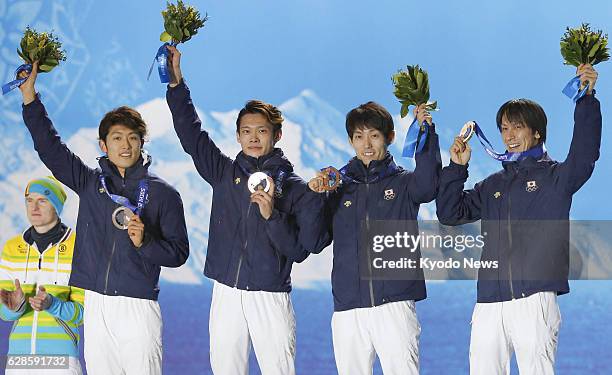 Russia - Members of the Japanese ski jumping team - Reruhi Shimizu, Taku Takeuchi, Daiki Ito and Noriaki Kasai - wave at the crowd during an awards...