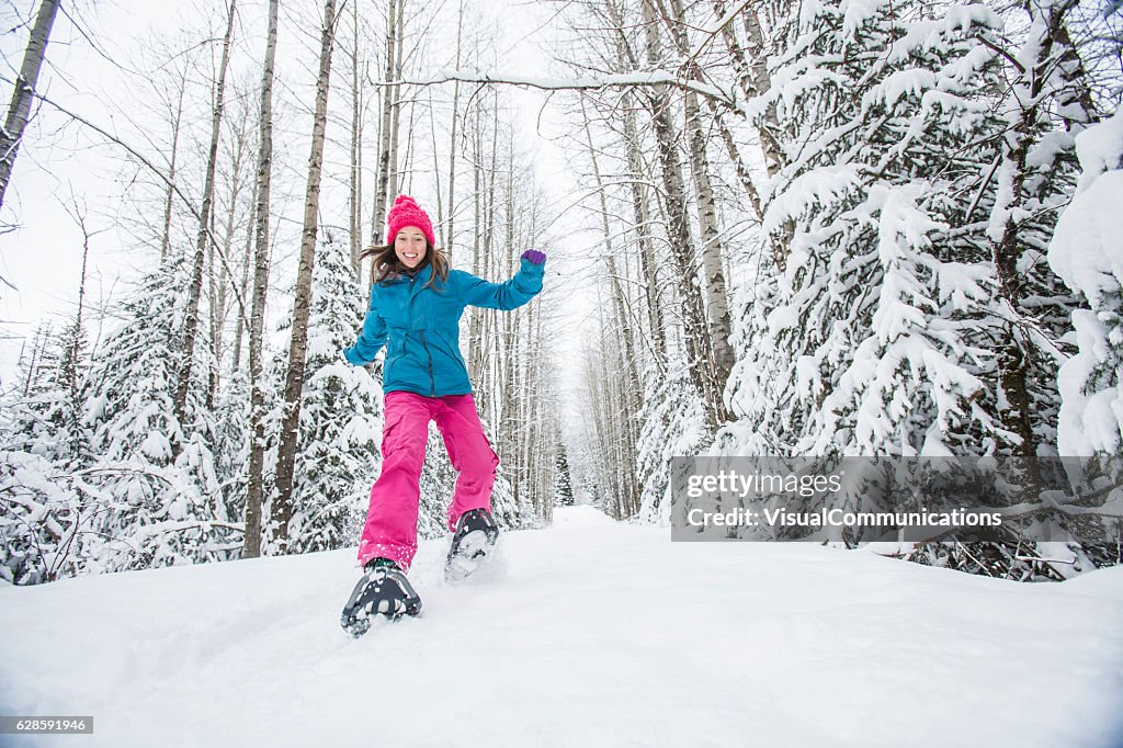 Young woman snowshoeing.