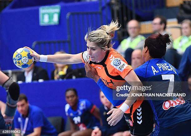 Netherlands' Estavana Polman and France's Allison Pineau vie for the ball during the Women's European Handball Championship Group B match between...