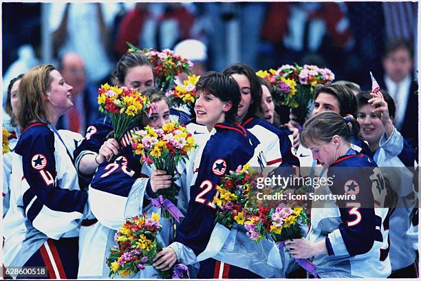 Cammi Granato and Team USA celebrate after their victory over Canada in the women's ice hockey gold medal game at the 1998 Winter Olympics in Nagano,...
