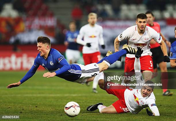 Fabian Reese of Schalke is challenged by Josip Radosevic of Salzburg during the UEFA Europa League match between FC Salzburg and FC Schalke 04 at Red...