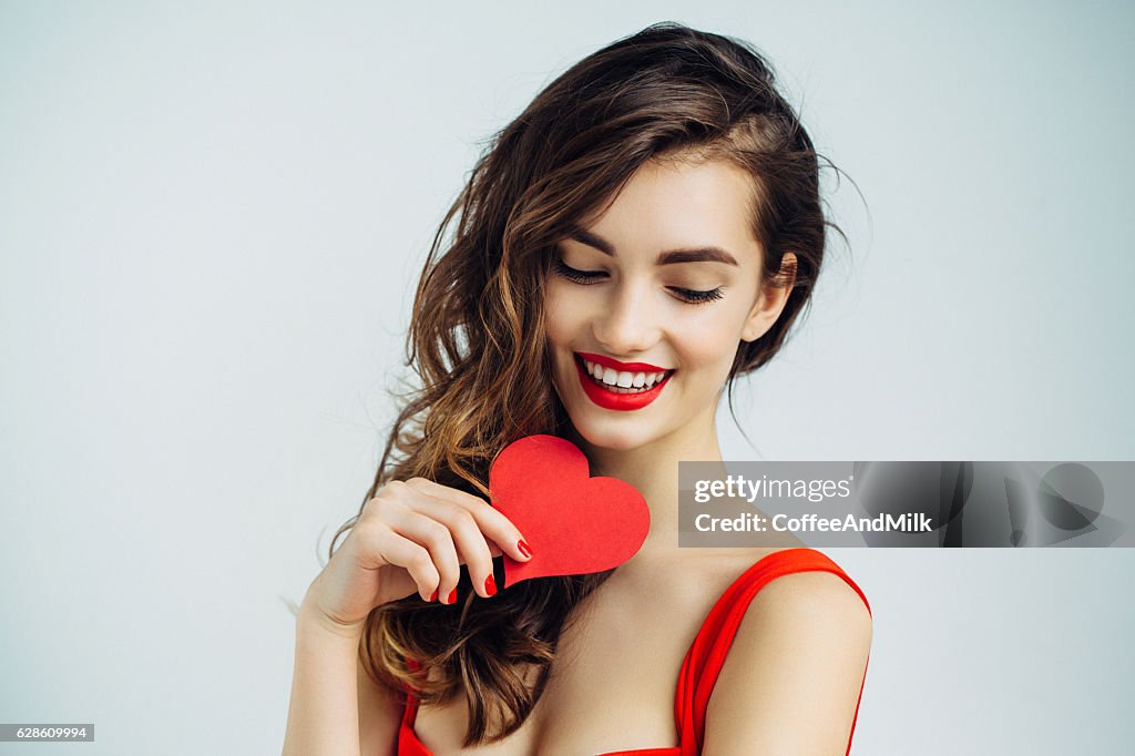 Beautiful girl holding artificial heart