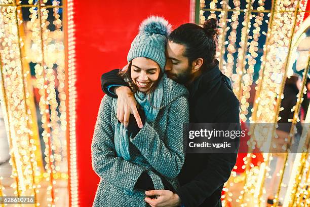 couple having fun outdoors at winter - christmas photo booth stock pictures, royalty-free photos & images