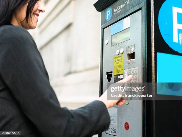 business woman paying th parking at the machine - happiness meter stock pictures, royalty-free photos & images