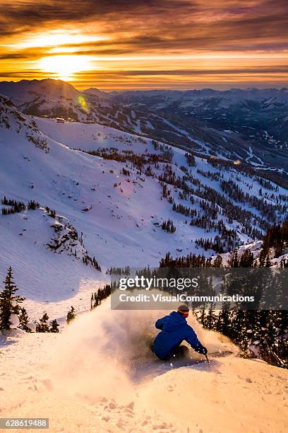 male athlete skiing in deep powder during sunset. - whistler stock pictures, royalty-free photos & images