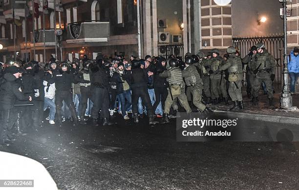 Fans of Ukraine's Zorya Luhansk and fans of Manchester United fight with each other as Ukrainian police try to prevent them before the UEFA Europa...