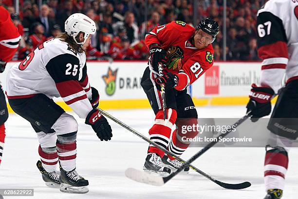 Chicago Blackhawks right wing Patrick Kane takes a shot past Arizona Coyotes center Ryan White during the first period of an NHL game between the...