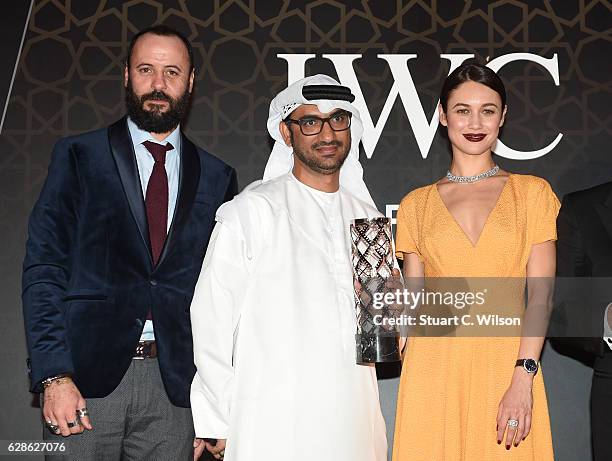 Ali Suliman, Actor , Abdullah Hassan Ahmed, Director , Olga Kurylenko , Actress and model attends the fifth IWC Filmmaker Award gala dinner at the...